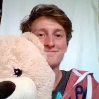 A picture of my face. I'm the one on the left, not the teddy bear.
